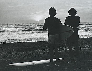 Surfers at sunset
